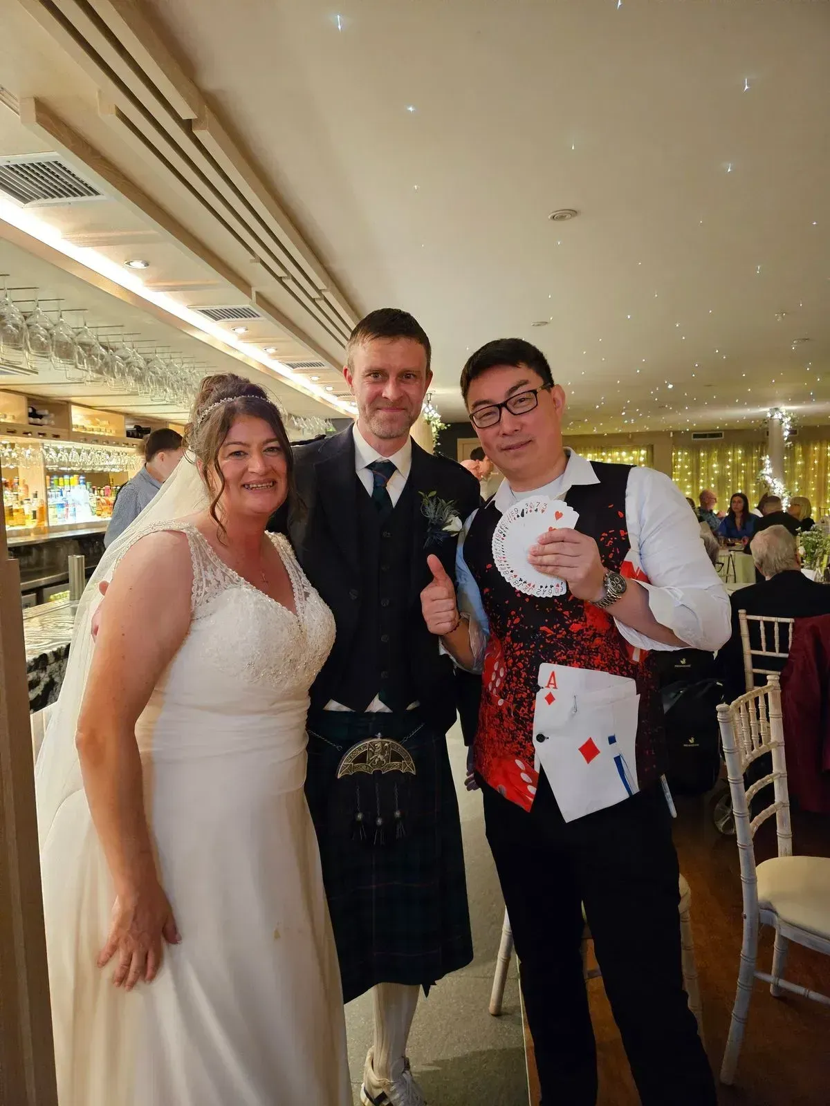 Magic Yin posing with a bride and groom at their wedding