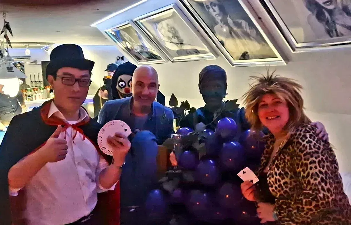 Magic Yin at a Halloween party with guests in costume
